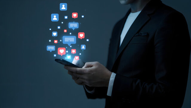 Elegant man in a suit uses his smartphone to engage on social media, with digital icons representing likes and comments floating above his phone display reflecting modern connection.