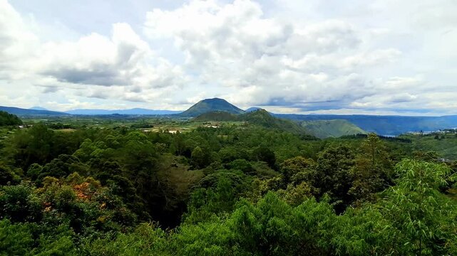 Forest landscape in the Parapat area, North Sumatra. Panoramic view of the green protected natural forest in the midday sun.