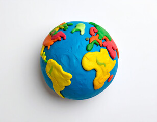 Fototapeta premium A colorful, handcrafted globe made of playdough, depicting continents like Africa, Europe and more on a bright blue ocean, against a white backdrop.
