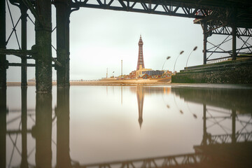 Blackpool Tower viewed from beneath the pier on a still overcast day 