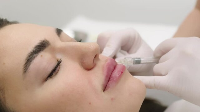 A beautician performing beauty injections on a young woman in a modern cosmetic clinic. Concept of skin rejuvenation, cosmetic procedures, and non-surgical facial enhancements for a youthful look.