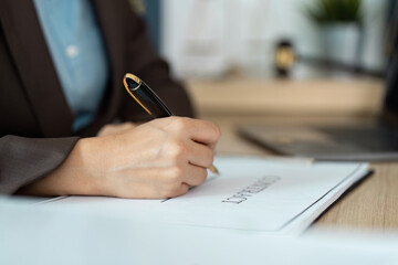 Lawyer Signing Legal Document. A professional woman writing on a contract in her office.