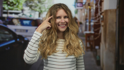 Woman head pointing idea thinking concept shown by blonde young subject standing on street urban...