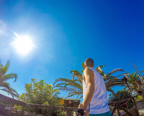 Man taking a selfie from behind In Sardinia