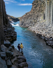 Explore the stunning beauty of Studlagil Canyon in Iceland under a clear blue sky
