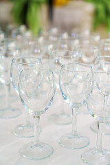 Lots of empty, clean glasses on the table.
