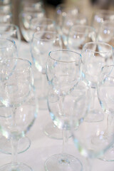 Lots of empty, clean glasses on the table.
