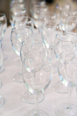 Lots of empty, clean glasses on the table.
