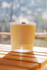 Scented candles on a wooden table.