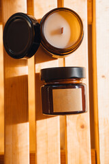 Scented candles on a wooden table.