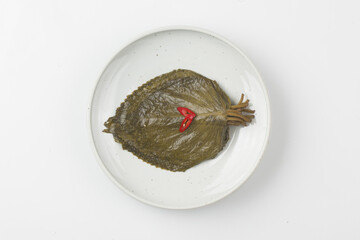   A pickled food made by soaking perilla leaves in salt water or soybean paste.
