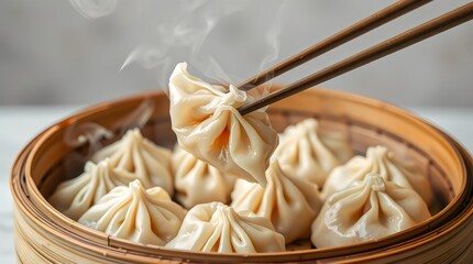 Bamboo steamer filled with piping-hot xiao long bao, steam rising as one dumpling is lifted