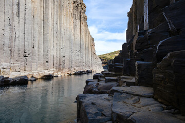 Explore the stunning natural beauty of Studlagil Canyon in Iceland under clear skies