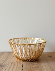 Fototapeta premium Gold Wire Bowl with White Interior on Wooden Table