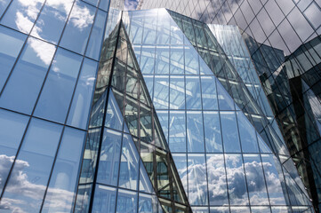 Glass architecture in Vilnius, Lithuania, with dynamic reflections and angular shapes. A modern,...