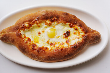 Explore the flavors of Adjarian khachapuri with egg and cheese