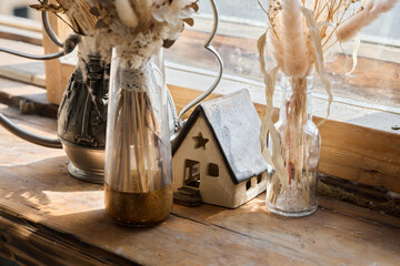 Explore home decor with lovely dried flowers and a miniature house that adds warmth