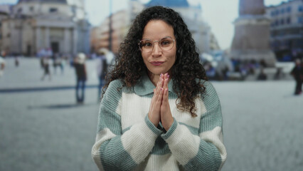 Woman standing in vatican city square with striped sweater and glasses, featuring blurred...