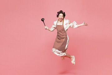 Full body young happy housewife housekeeper chef cook baker woman wear brown apron jump high hold...