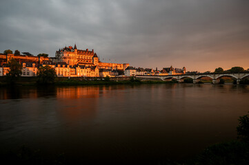 Wide shot of Amboise castle and the Loire river at sunset