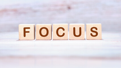 The concept word FOCUS is assembled from cubes. Search for words and information concept