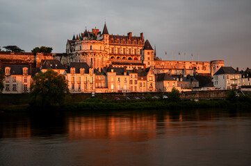 Medium shot of Amboise castle bathing in golden hour light at sunset