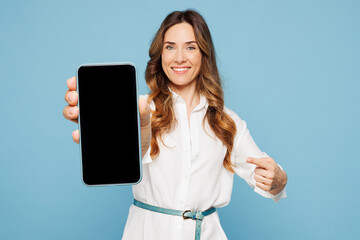 Obraz na płótnie Canvas Young employee business woman corporate lawyer in shirt classic formal clothes work in office hold use point on blank screen area mobile cell phone isolated on pastel blue background studio portrait