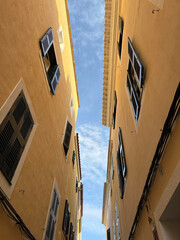 Perspective view of a typical town street in ciutadella menorca with winding cobbled road old...