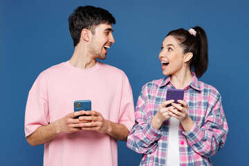 Young amazed happy couple two friends family man woman they wear pink casual clothes together hold...