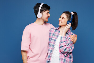 Young couple two friends family man woman they wear pink casual clothes together listen to music in...