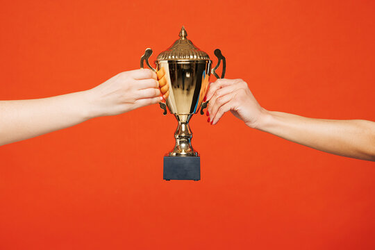 Close up cropped female hold in hand golden champion cup trophy isolated on pastel plain light blue color wall background studio. Soccer football sport match concept. Copy space advertising mock up. - Powered by Adobe