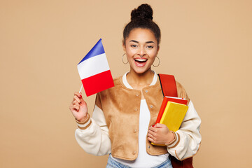 Young smiling happy smart girl student she wear casual clothes backpack bag hold books French flag...