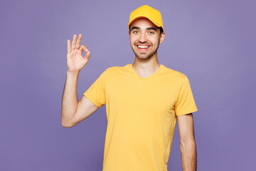 Professional smiling fun delivery guy employee man wear yellow cap t-shirt uniform workwear work as...