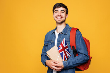 Young smiling clever English boy student he wearing denim casual clothes backpack bag hold books...