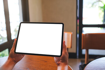 Mockup image of a woman holding digital tablet with blank white desktop screen