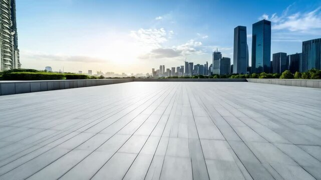 Cityscape view from a modern grey stone tiled patio with tall skyscraper buildings on the horizon against a clear blue sky.