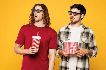 Young shocked scared sad two friends buddies men wear casual clothes 3d glasses watch movie film...
