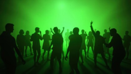 Silhouettes of people dancing in a green light.