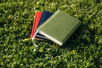 Notepads on the green grass, close up view