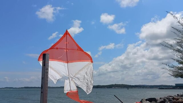 Red and white kite emulating Indonesian National Flag