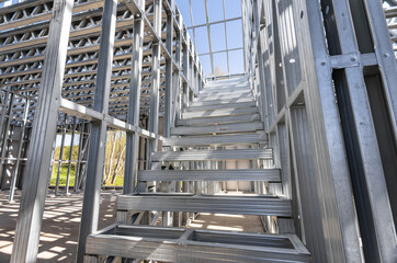Fire exit stair of large factory building. Galvanise metal stair step. Metal frame of the stairs.
