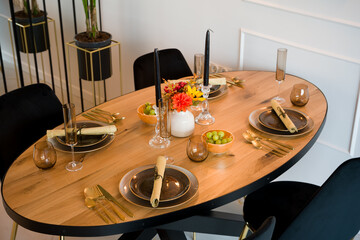 Elegant table setting on a wooden dining table for a festive dinner