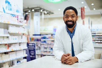 Fototapeta premium Friendly Pharmacist Standing in a Modern Pharmacy with Shelves of Medicines
