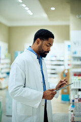 Pharmacist Using Digital Tablet in Modern Pharmacy for Inventory Management