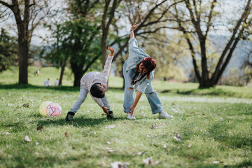 A mother and her young child share a joyful moment playing together outdoors in a park. Bright...