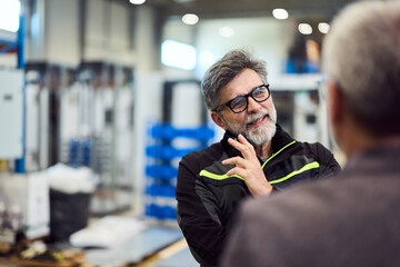 Confident Professional Discussing Business Concepts in a Modern Industrial Environment