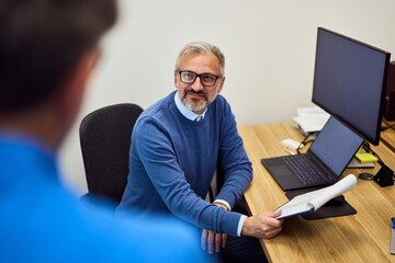 Professional Colleague Discussing Work in an Office During a Meeting