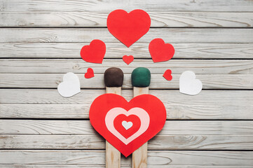 Two big matches and hearts as symbols of love on a wooden background. Valentine's Day, February 14,...