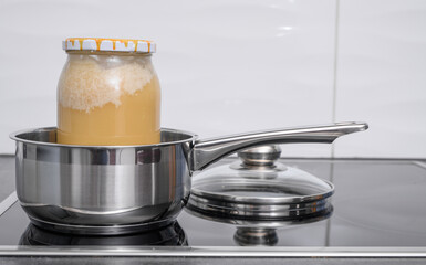 Dissolve the crystallized honey in a pot of warm water