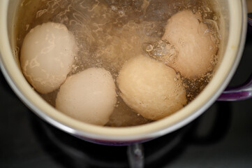 Boil hard-boiled eggs in a pot, top view